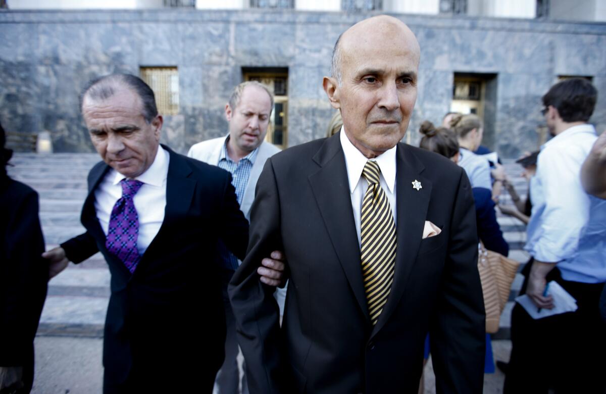 Former Los Angeles County Sheriff Lee Baca leaves a downtown courthouse in February after pleading guilty to lying to federal investigators.