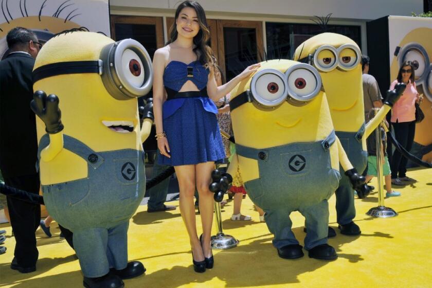 Miranda Cosgrove poses with minion characters at the premiere of "Despicable Me 2."