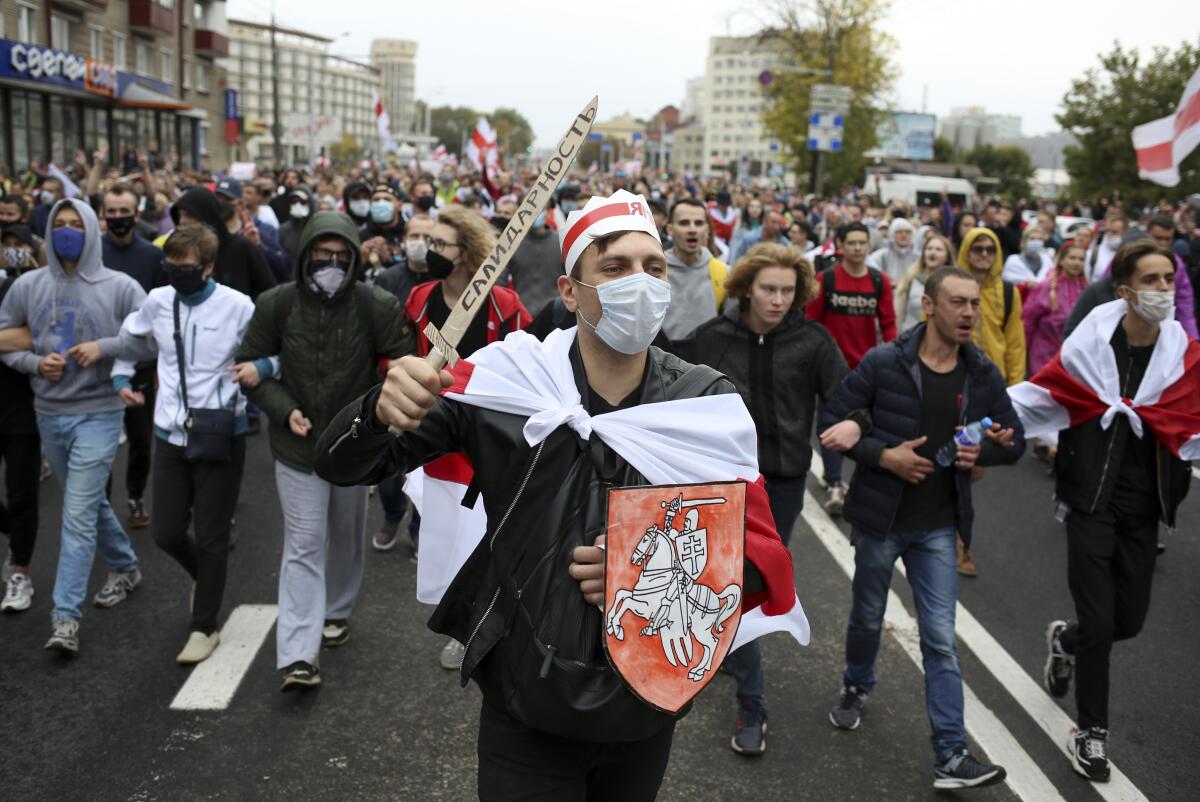 Demonstrators march during an opposition rally to protest official presidential election results on Sunday in Minsk, Belarus.