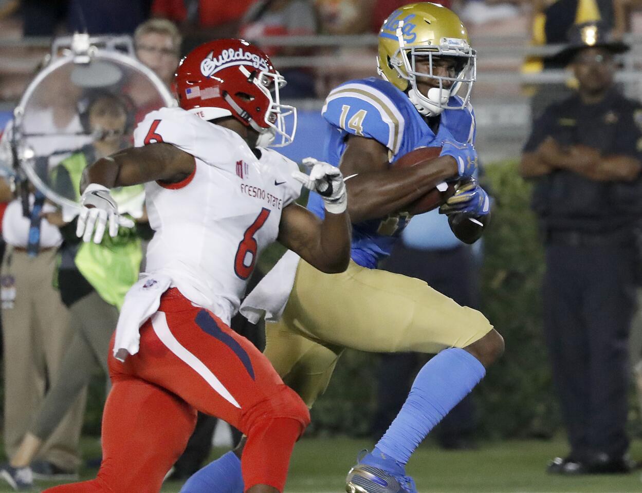 UCLA wide receiver Theo Howard breaks away for a touchdown after making catch in front of Fresno State defensive back Tank Kelly in the second quarter on Saturday.