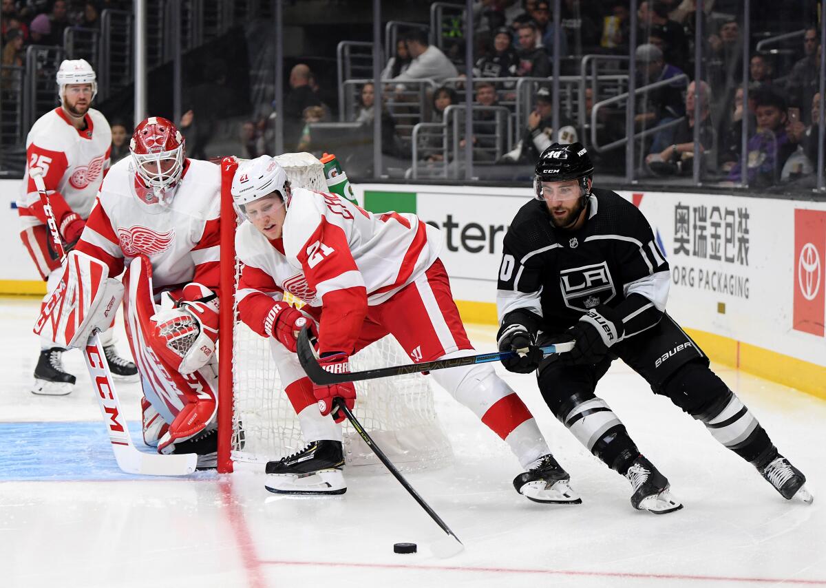 Kings center Michael Amadio (10) eyes the puck in front a pack of Red Wings during a game Nov. 14 at Staples Center.