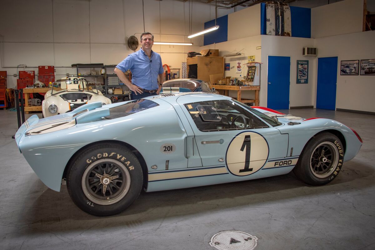Aaron Shelby stands at his company offices in Gardena with the original Ken Miles’ driven GT40 depicted in “Ford v Ferrari.”
