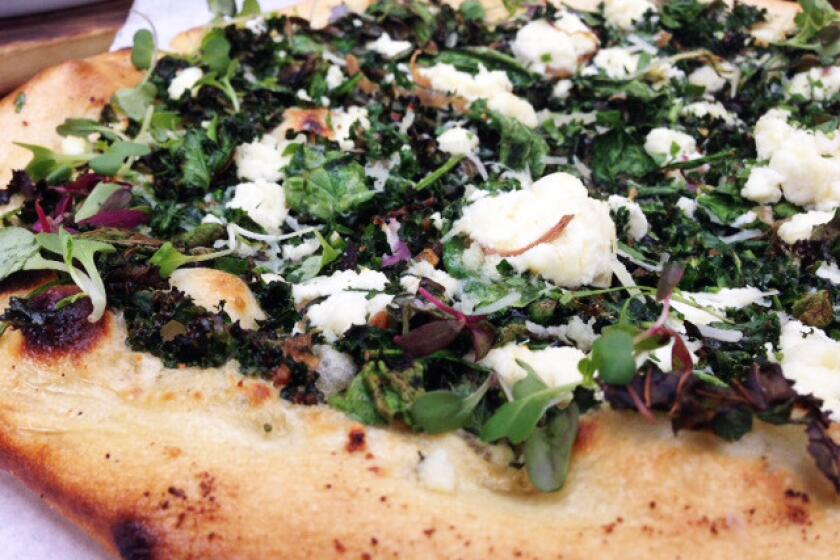 The new spinach and kale pizza with ricotta and a Parmesan cream sauce.