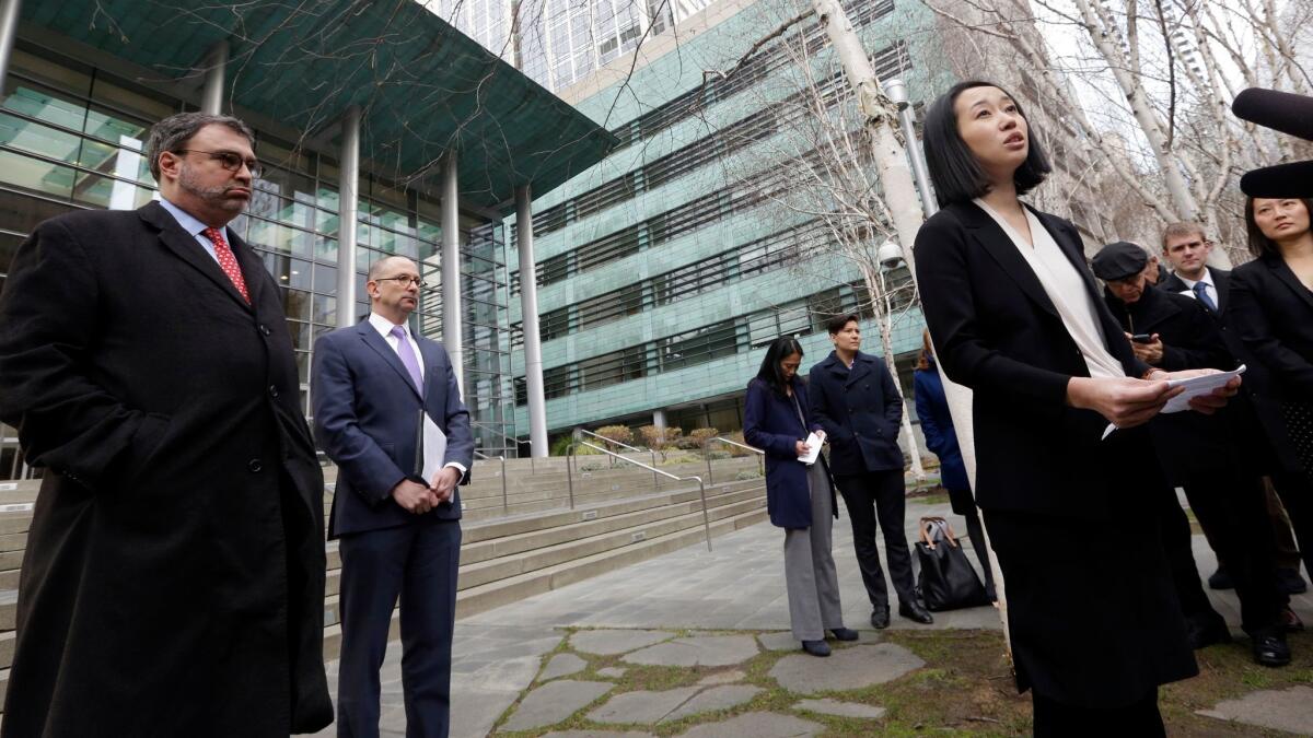 Mariko Hirose, right, an attorney for the Jewish Family Service, addresses reporters Thursday outside a federal court in Seattle.