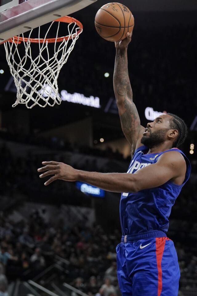 Clippers forward Kawhi Leonard dunks the ball against the Spurs during a game Nov. 29.