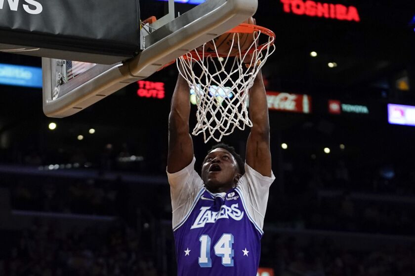 Los Angeles Lakers forward Stanley Johnson (14) dunks during the first half of an NBA basketball game against the Oklahoma City Thunder in Los Angeles, Friday, April 8, 2022. (AP Photo/Ashley Landis)