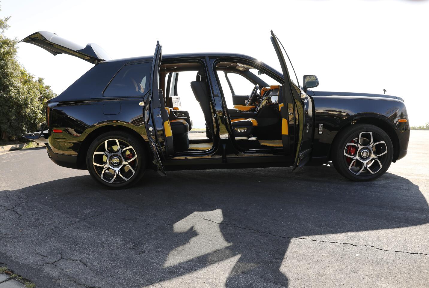 The Rolls-Royce Cullinan Black Badge with its suicide doors and winged hatch open.