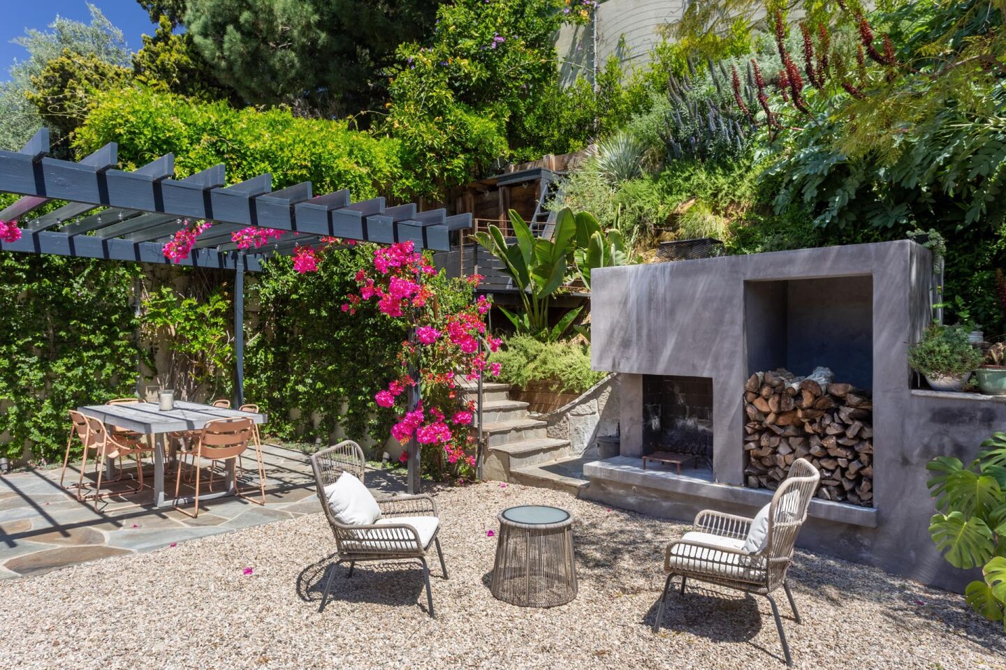 The backyard features a fireplace and a Tuscan grill.