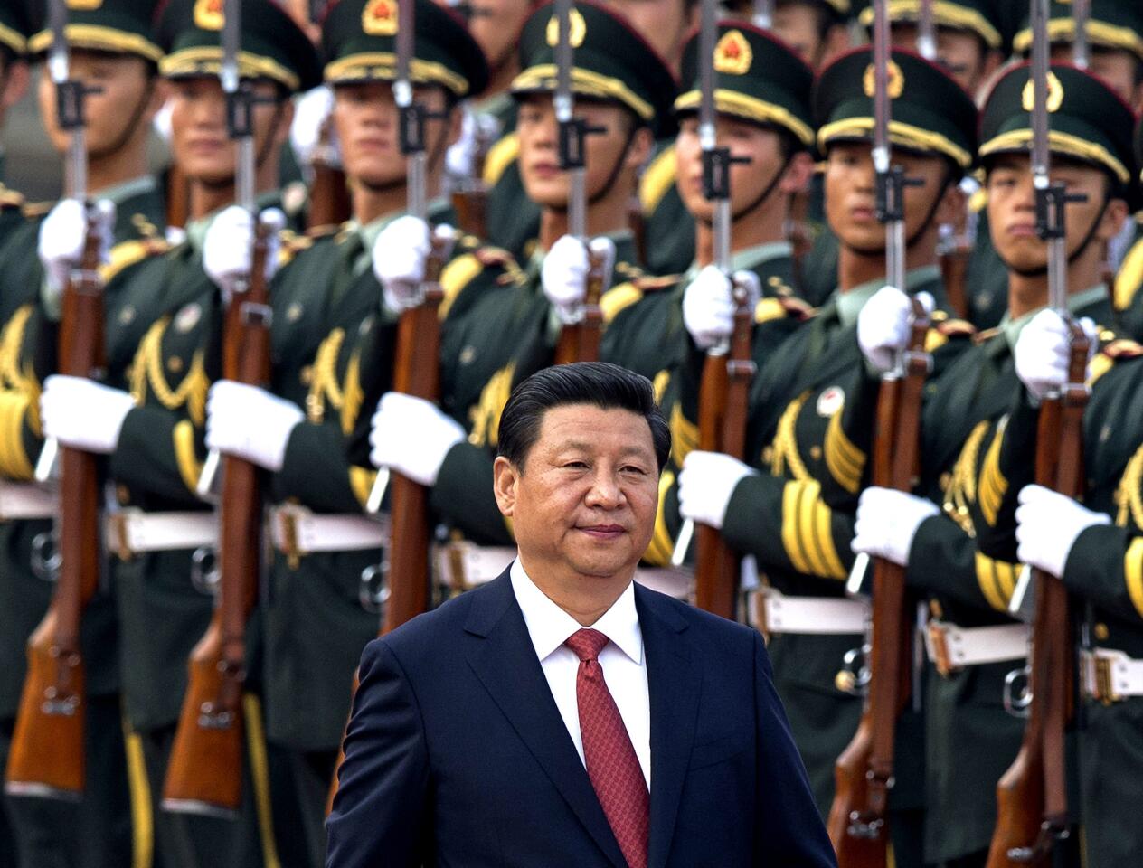 Chinese President Xi Jinping inspects an honor guard outside the Great Hall of the People in Beijing. China's plan to create a new security committee points to Xi's effort to cement his authority as Communist Party leader, analysts said in November.