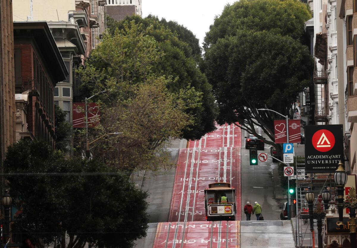 A couple approaches an empty cable car on March 16 in San Francisco.