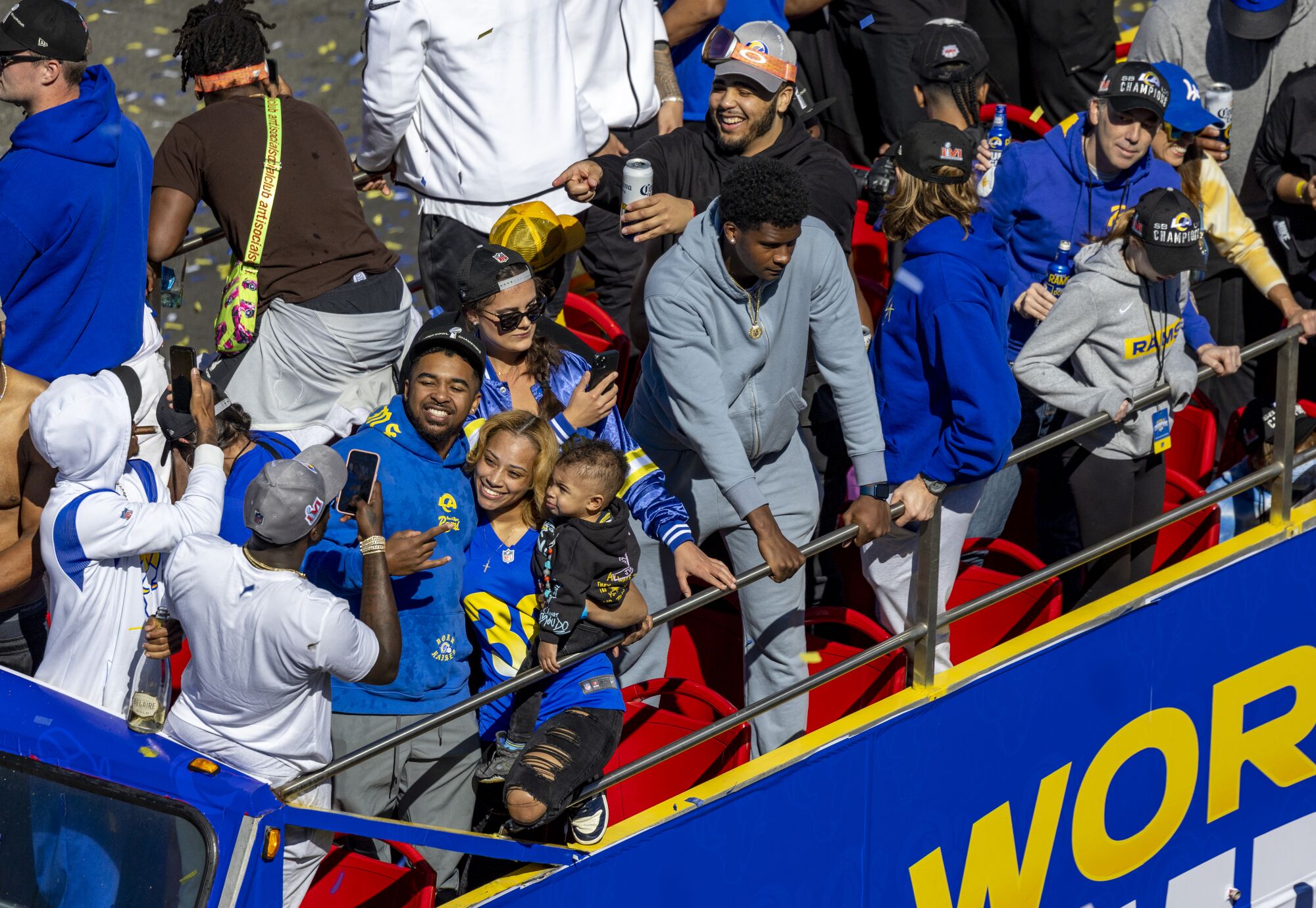 A Rams player gets his photo taken with family aboard double-decker buses during the Rams victory parade.