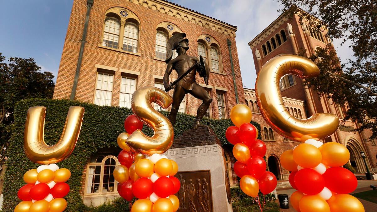 Balloons spell out "USC" in front of the Tommy Trojan statue on the university's campus. 