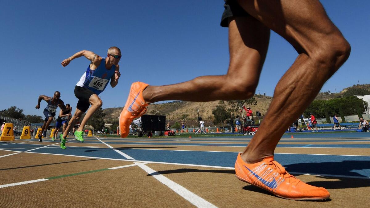 Police and firefighters compete Tuesday in the men's 800-meter race during the World Police and Fire Games at West Los Angeles College.