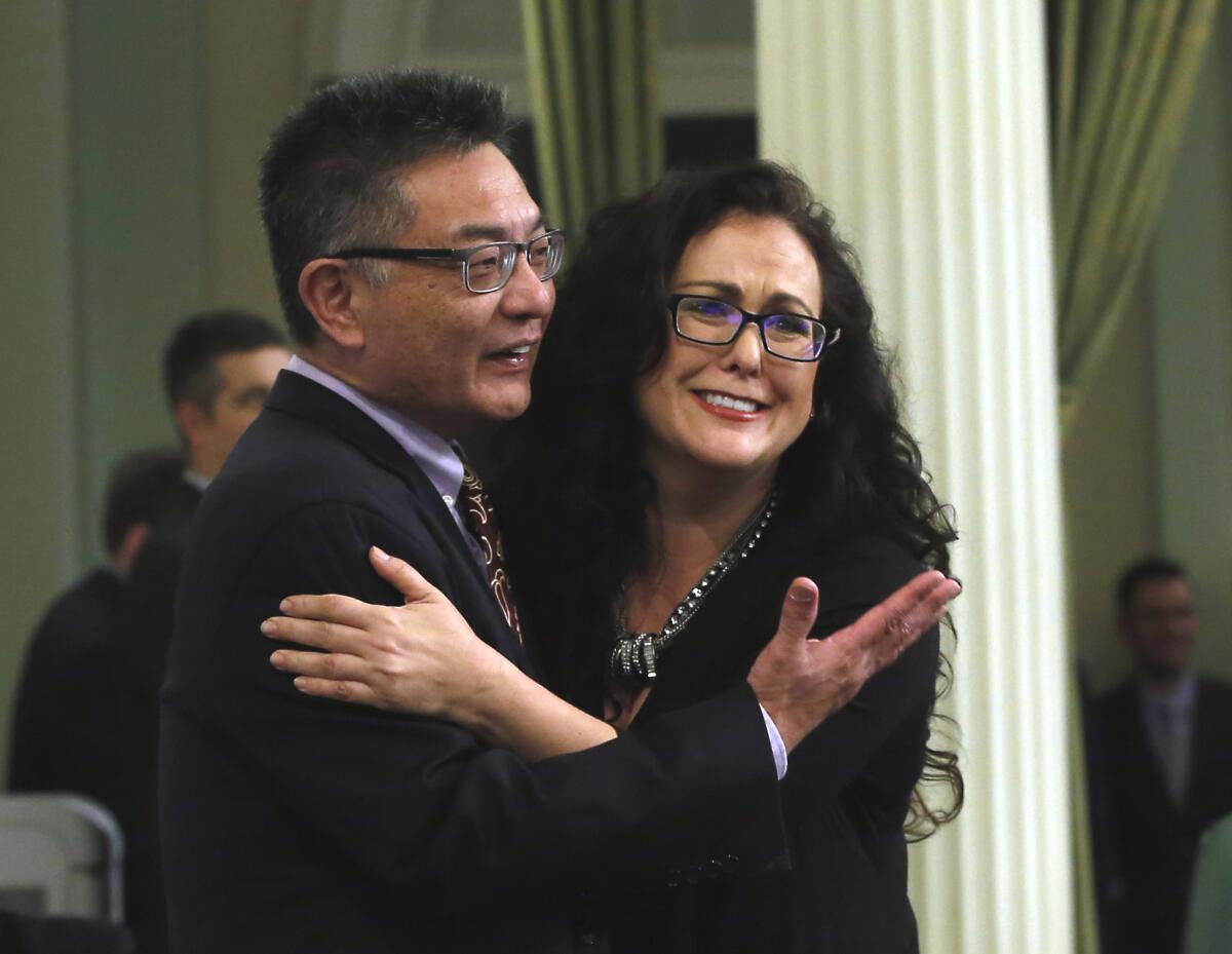 Assemblywoman Lorena Gonzalez, D-San Diego, is congratulated by Kansen Chu, D-San Jose, after her bill to give double-time for working on Thanksgiving, was approved by the Assembly, Wednesday, Jan. 27, 2016, in Sacramento, Calif. (AP Photo/Rich Pedroncelli)