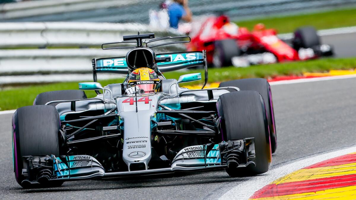 Formula One driver Lewis Hamilton leads Sebastian Vettel through some corners at the Spa-Francorchamps race track on Sunday.