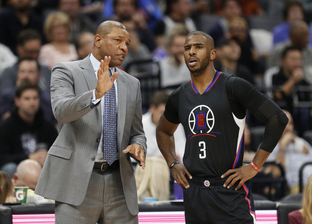 Clippers Coach Doc Rivers talks with point guard Chris Paul during the first half against the Kings earlier in the season.