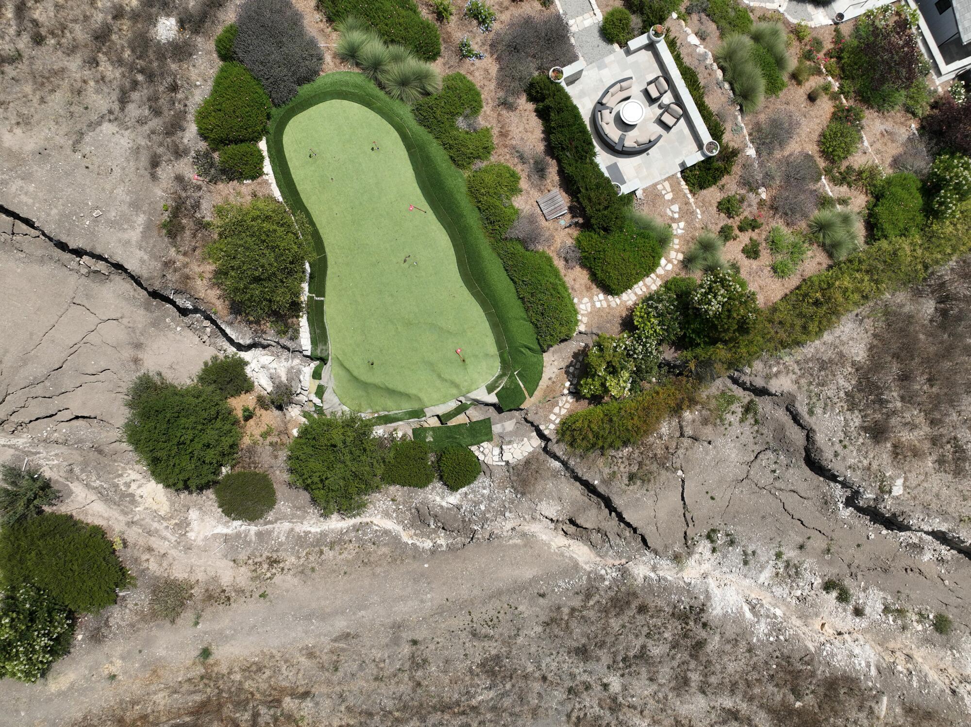  An aerial view of a large fissure that has opened up since February, damaging a Portuguese Bend putting green and home.