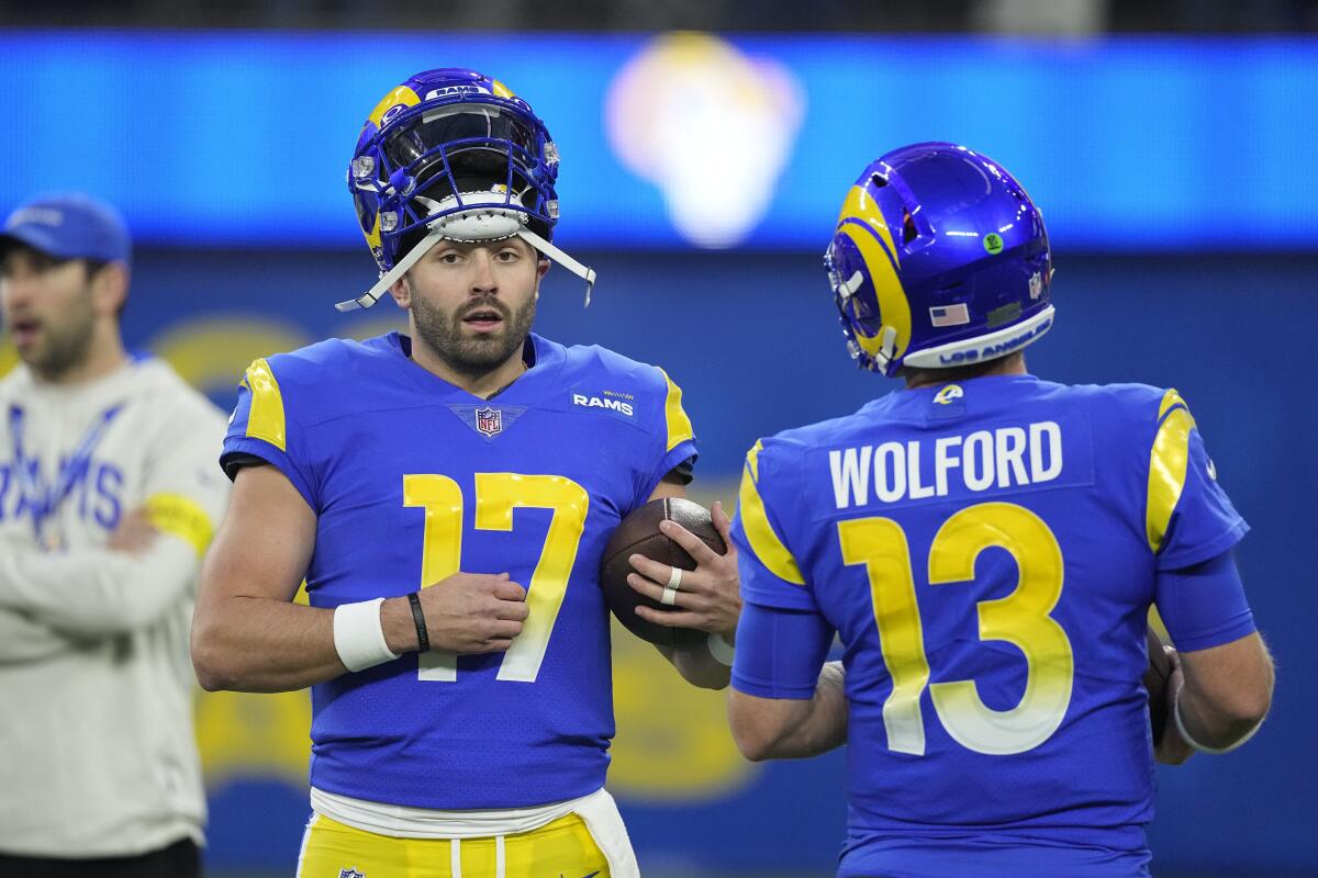 Rams quarterback Baker Mayfield, left, talks with quarterback John Wolford before the game.