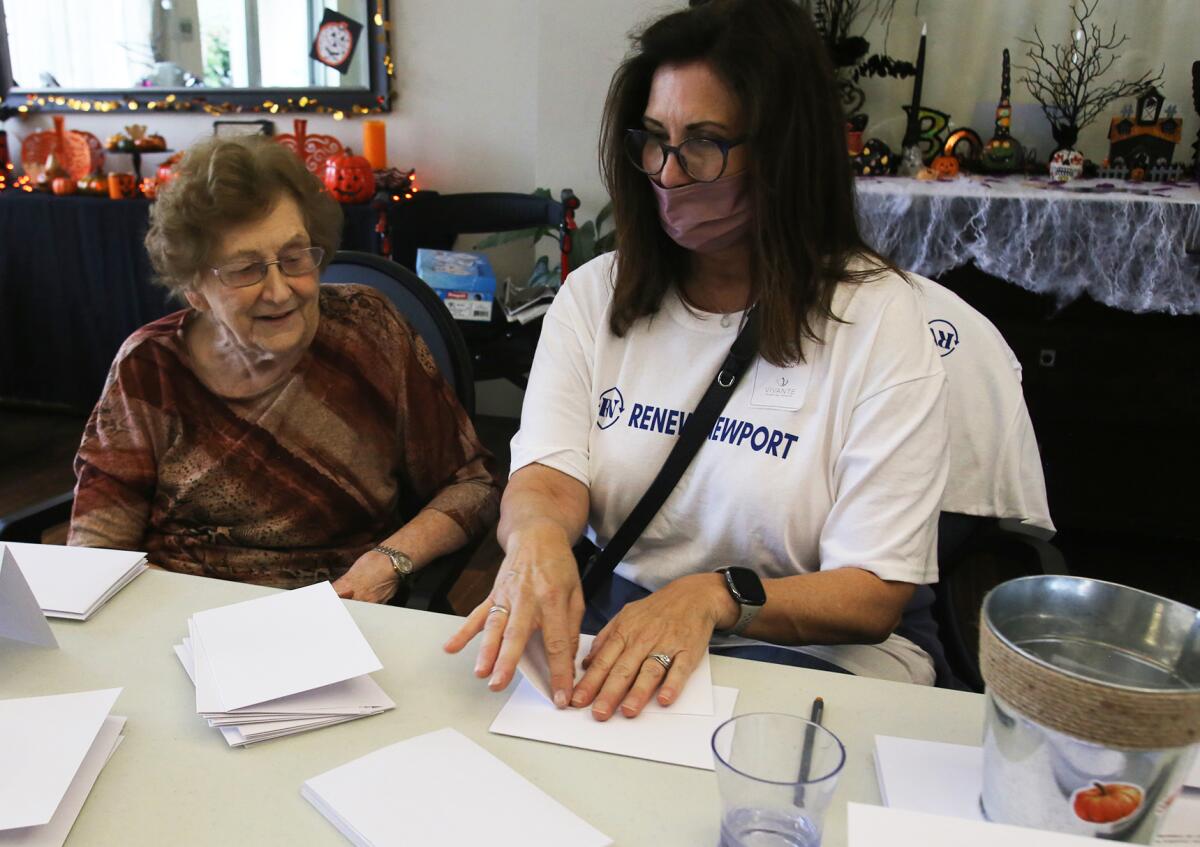 Laurie Kelly, of Newport Beach, right, makes get well cards with her mother Beverly Hefner.