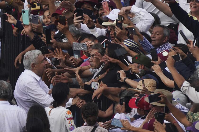 Mexican President Andrés Manuel López Obrador greets supporters as he arrives at the capital's main square, the Zócalo, in Mexico City, Sunday, November 27, 2022. (AP Photo/Marco Ugarte)