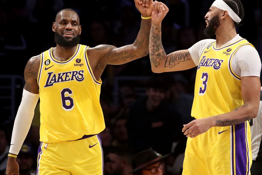 LOS ANGELES, CALIF. - NOV. 30, 2022. Lakers forward LeBron James, left, celebrates with teammate Anthony Davis after scoring a basket against the Blazers in the fourth quarter of the game at crypto.com Arena in Los Angeles on Wednesday night, Nov. 30, 2022. (Luis Sinco / Los Angeles Times)
