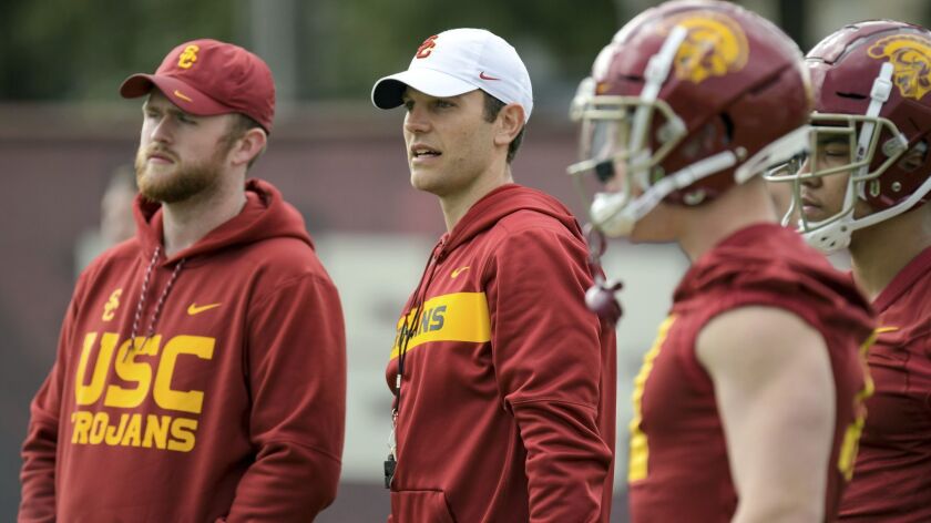 USC offensive coordinator Graham Harrell, center, watches practice on the campus of USC.