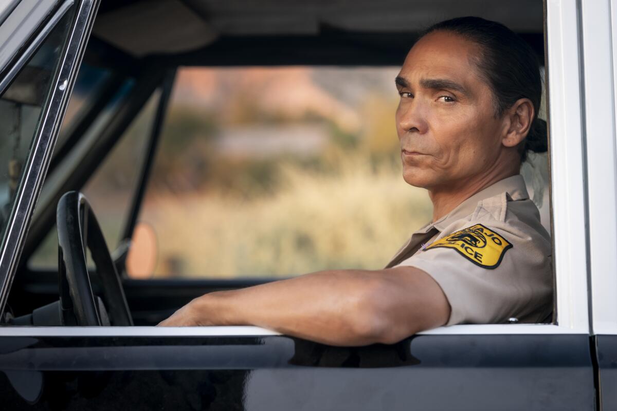 A police officer looking out the window of his cruiser