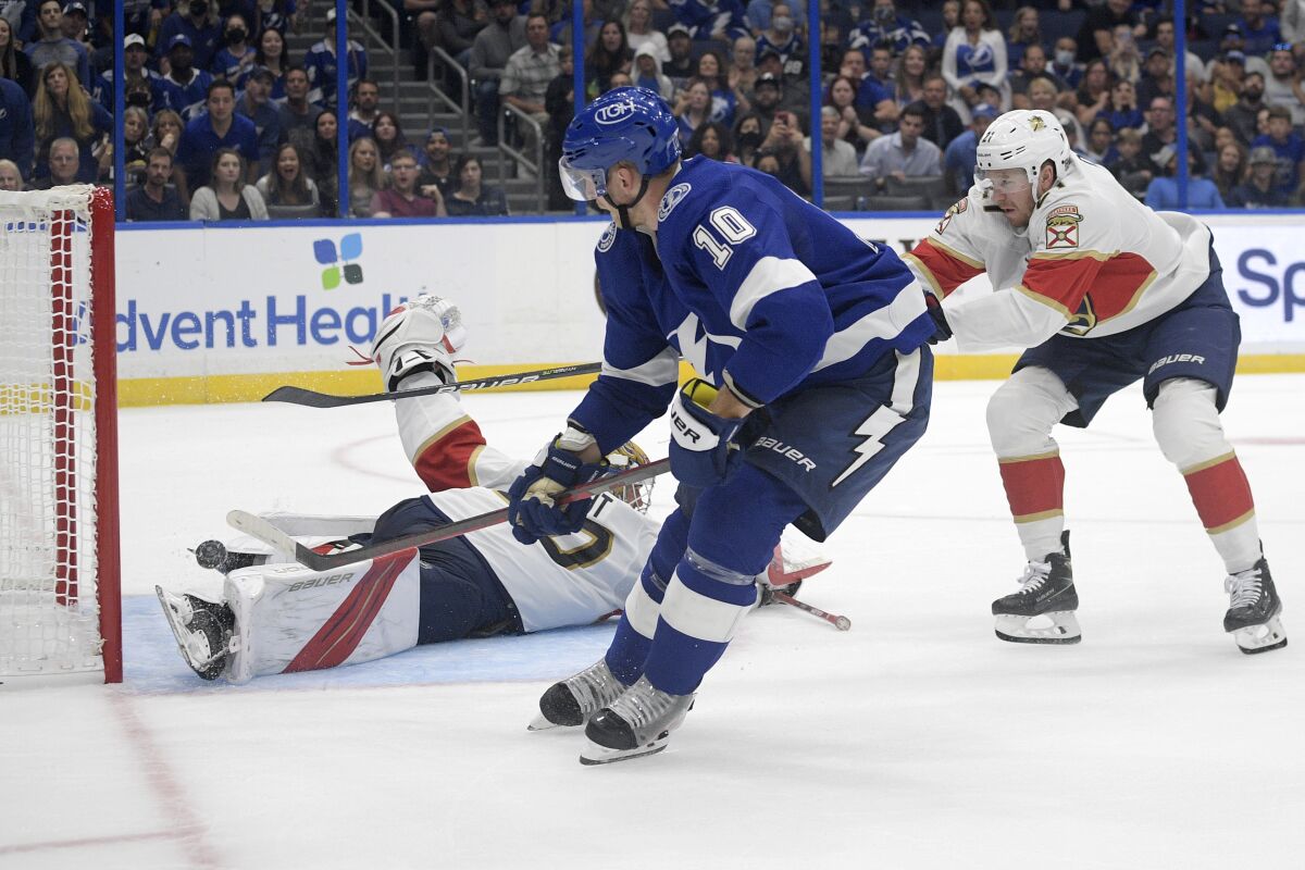 Tampa Bay Lightning right wing Corey Perry (10) scores past Florida Panthers goaltender Spencer Knight and center Zac Dalpe, right, during the second period of a preseason NHL hockey game Thursday, Oct. 7, 2021, in Tampa, Fla. (AP Photo/Phelan M. Ebenhack)