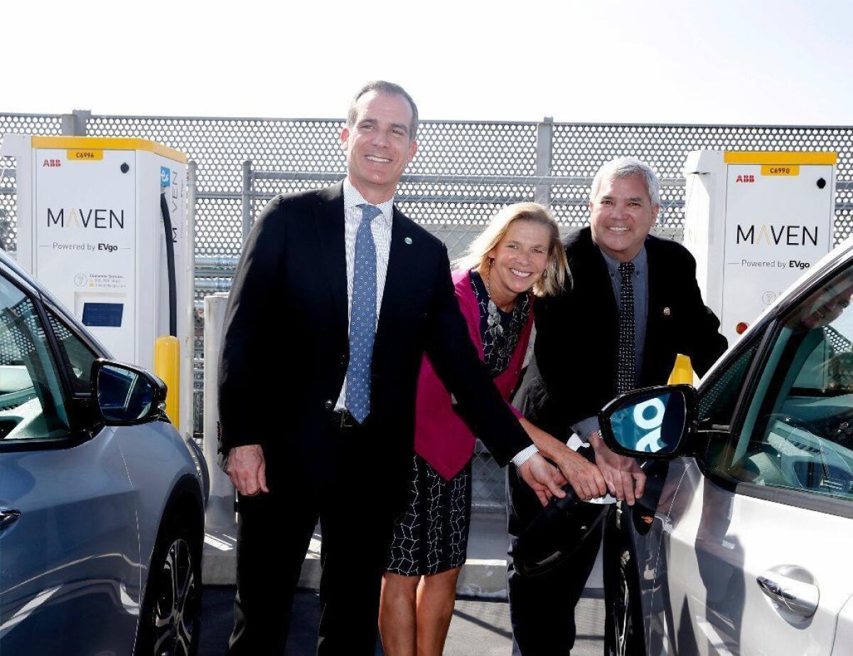 Los Angeles Mayor Eric Garcetti, EVgo Chief Executive Cathy Zoi and Culver City Mayor Thomas Small demonstrate how a Maven electric vehicle charging station works during the unveiling of EvGo network charging stations in Los Angeles on April 22.