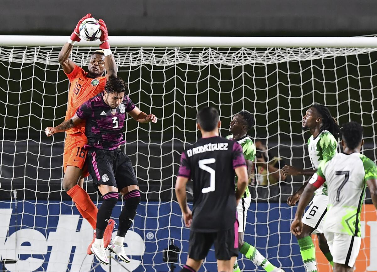 Nigeria goalkeeper Bobo Stanley Nwabili grabs the ball in front of Mexico's Carlos Salcedo.