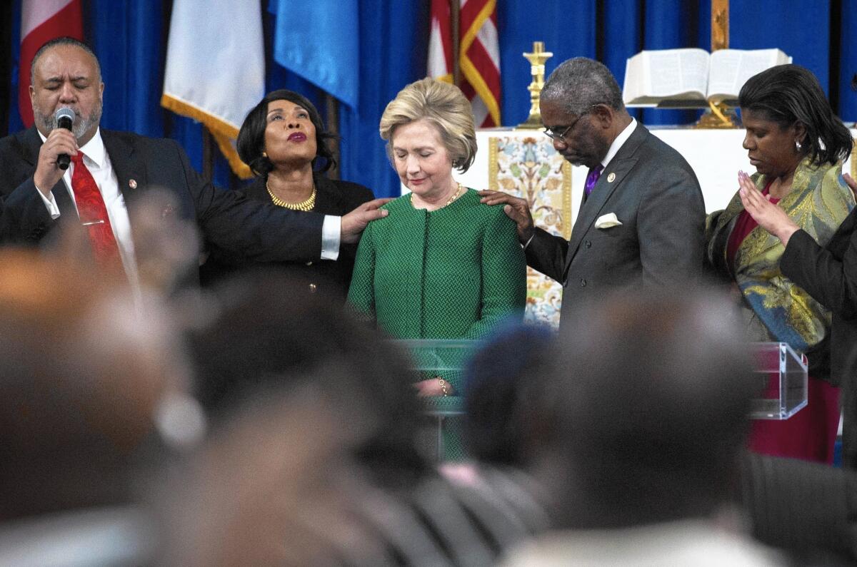 Hillary Clinton bows in prayer after speaking at New Greater Bethel Ministries in Queens, N.Y.