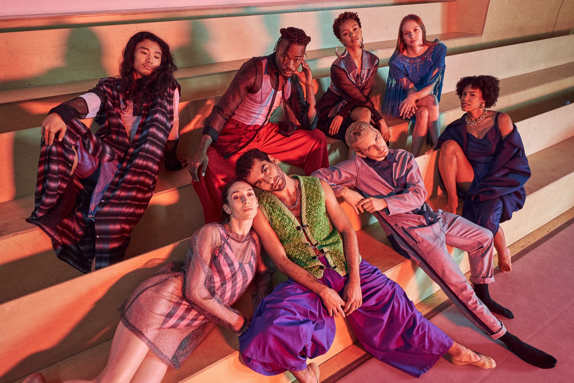 Eight LADP dancers posing on the bleachers of their dance studio
