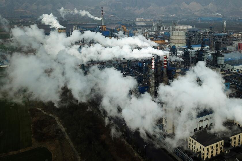 Smoke and steam rise from a coal processing plant in Hejin in central China's Shanxi Province