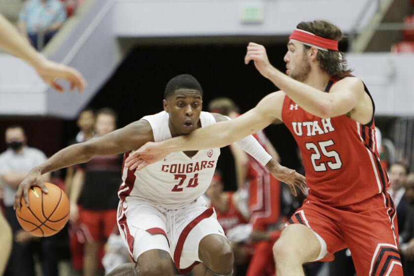 Washington State guard Noah Williams (24) drives the ball while pressured by Utah guard Rollie Worster (25) during the second half of an NCAA college basketball game, Wednesday, Jan. 26, 2022, in Pullman, Wash. Washington State won 71-54. (AP Photo/Young Kwak)