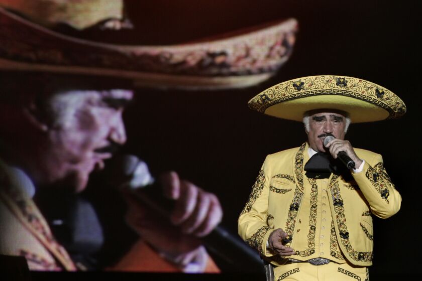 FILE - In this Saturday Feb. 21, 2009 file photo, Mexican singer Vicente Fernandez performs in Cali, Colombia. The Ranchera music giant told the Mexican station Televisa, Wednesday Feb. 8, 2012, that he will retire after tours of Latin America, Spain and the U.S., ending a four-decade career. (AP Photo/Christian Escobar Mora, File)