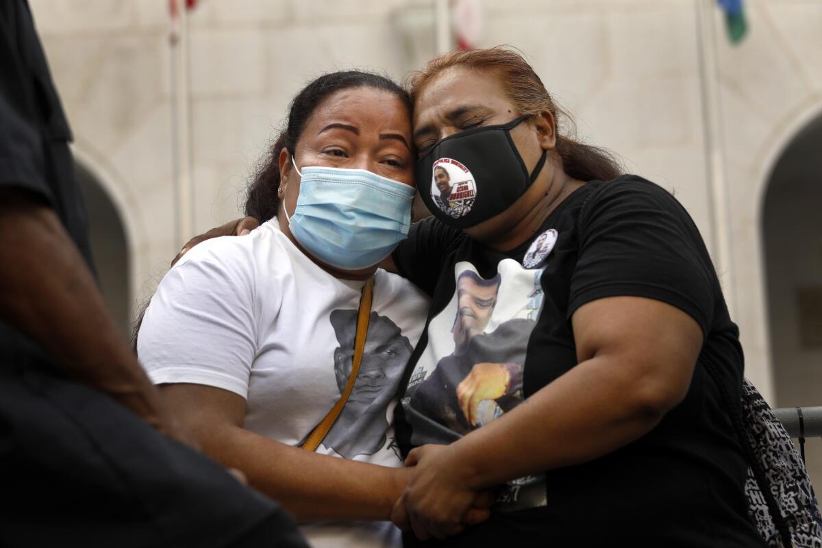 Teresa Dominguez, left, and Rosa Morena hug  at a Black Lives Matter rally