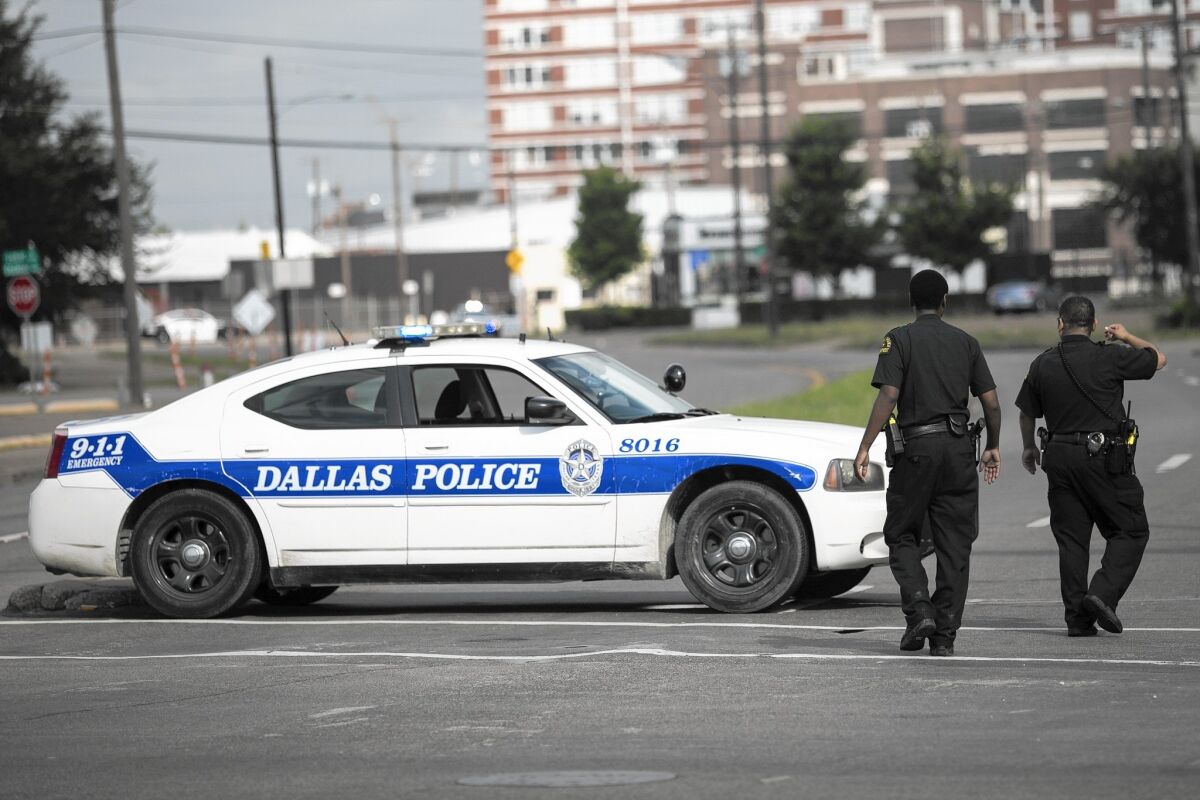 Dallas police close off a street after a shooting. Citizens with the Cop Block campaign film traffic stops and watch officers for potential violations of search laws. The Arlington chapter does so with a Texas flair.