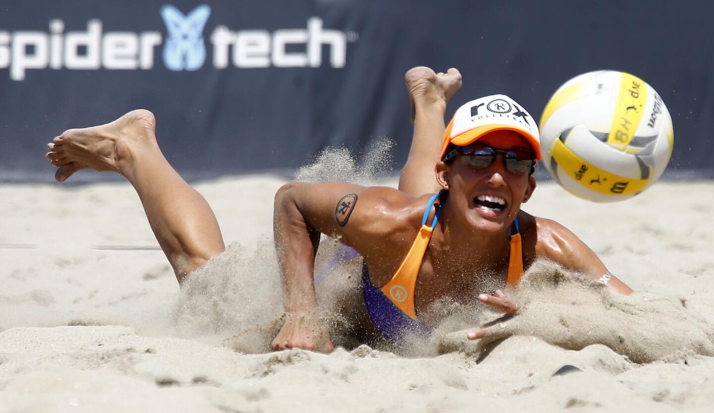 Emily Stockman can't reach the ball during a match against Whitney Pavlik and Sheila Shaw on Saturday at the AVP Huntington Beach Open.