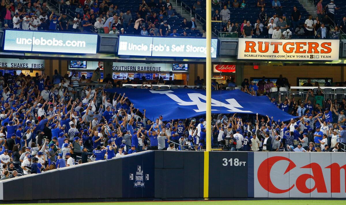 Dodgers fans unfurl a banner during the third inning of a game against the New York Yankees at Yankee Stadium on Sept. 12.