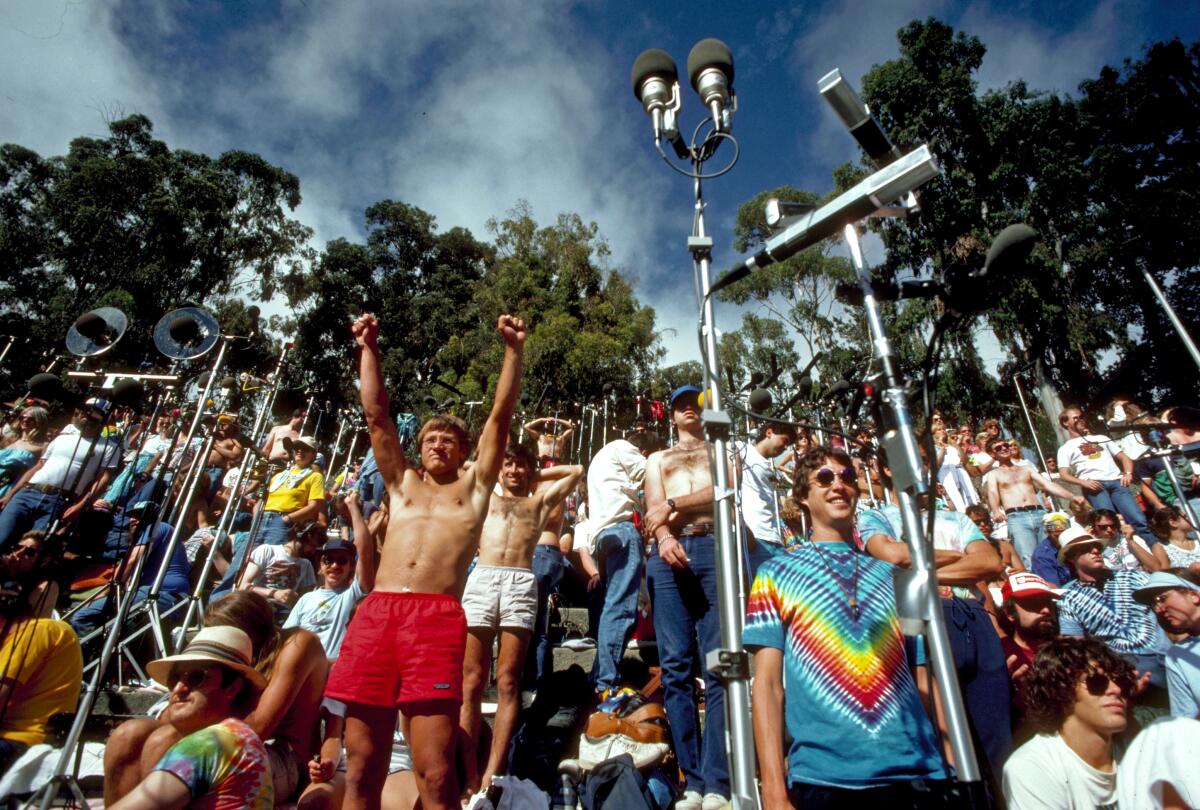 Concertgoers stand and cheer amid microphones being used to record a Grateful Dead show in Berkeley in 1987.