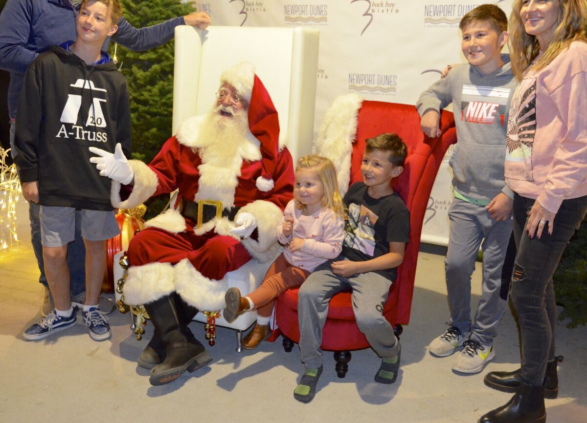 The Kitchen family from Las Vegas shares a visit with Santa at the tree-lighting celebration.