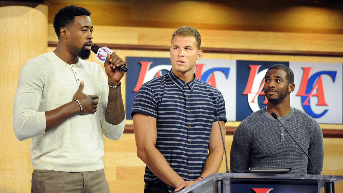 Clippers teammates (from left to right) DeAndre Jordan, Blake Griffin and Chris Paul attend a rally at Staples Center to introduce Steve Ballmer as the team's new owner in August.