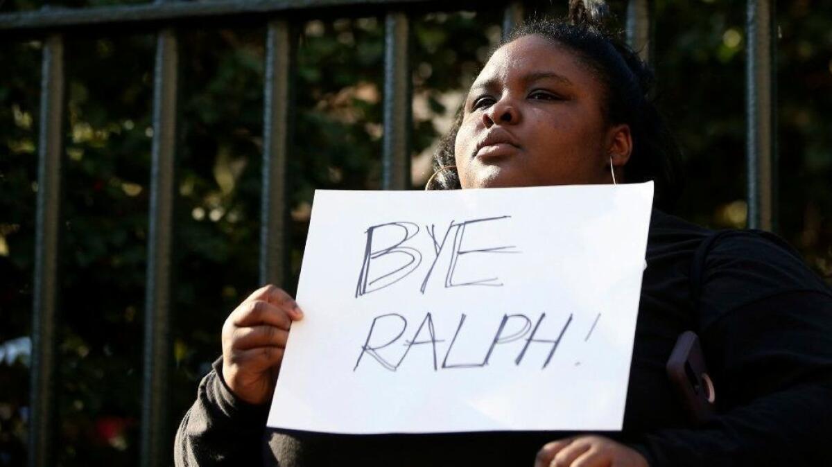 Zyahna Bryant of Charlottesville, Va., holds a sign at a protest Feb. 4 calling for Gov. Ralph Northam to resign.