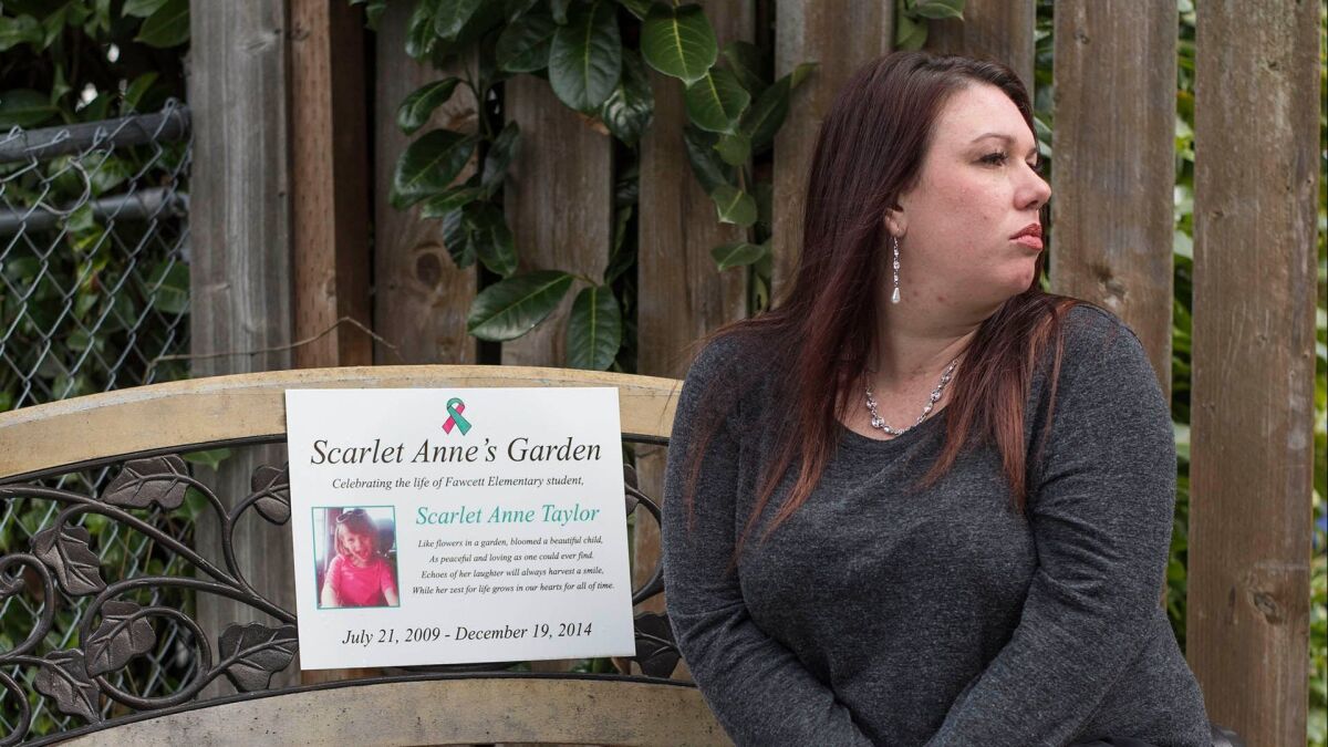 Rebecca Hendricks sits in her front garden on a bench dedicated to her late daughter, Scarlet Anne Taylor, who died at age 5 following a battle with influenza.