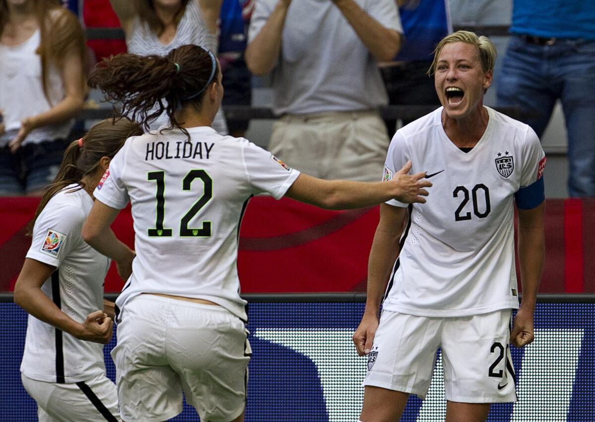 U.S. forward Abby Wambach (20) celebrates with teammates Lauren Holiday (12) and Tobin Heath after scoring against Nigeria at the end of the first half Tuesday in Vancouver.