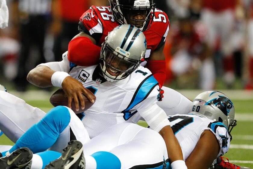 Panthers quarterback Cam Newton (1) is hit by Falcons linebacker Sean Weatherspoon (56) after pushing for a first down on Oct. 2.