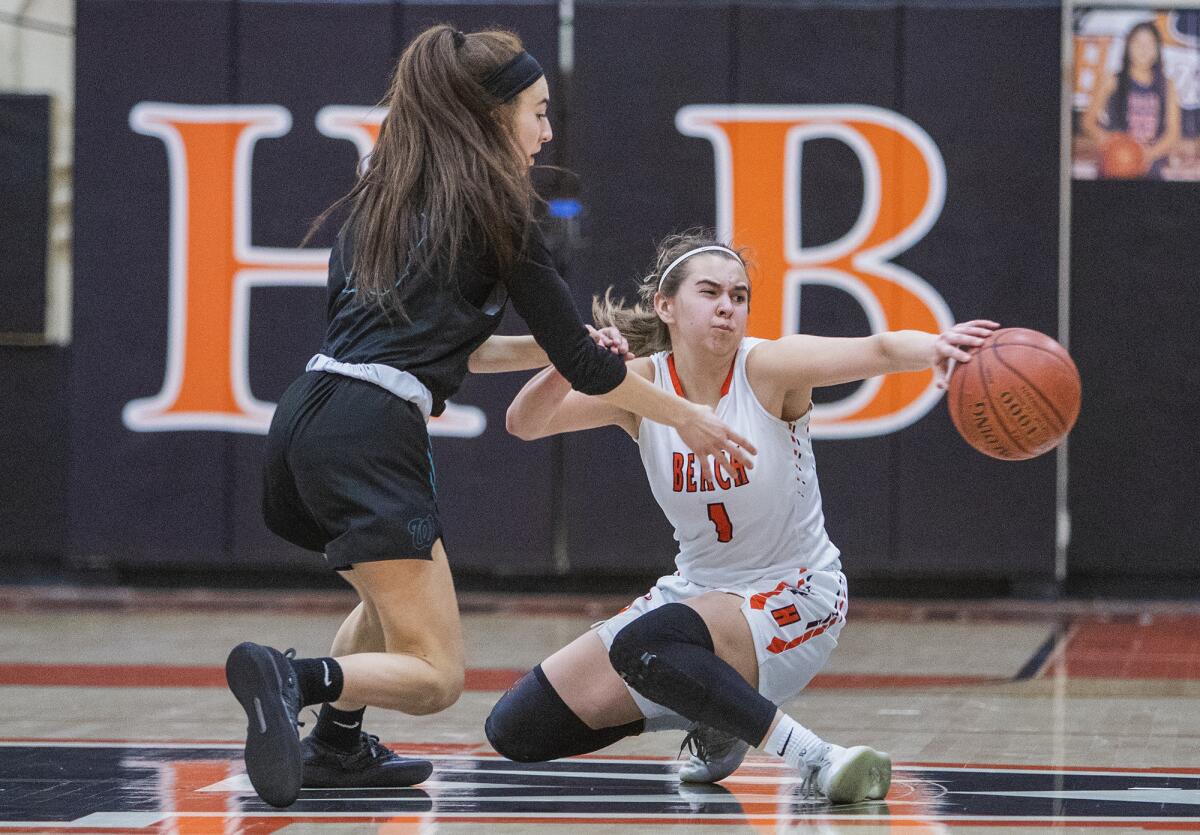 Huntington Beach's Alyssa Real, right, and Aliso Niguel's Karina Cabrera scramble for a loose ball in the first round of the CIF Southern Section Division 1 playoffs on Thursday.