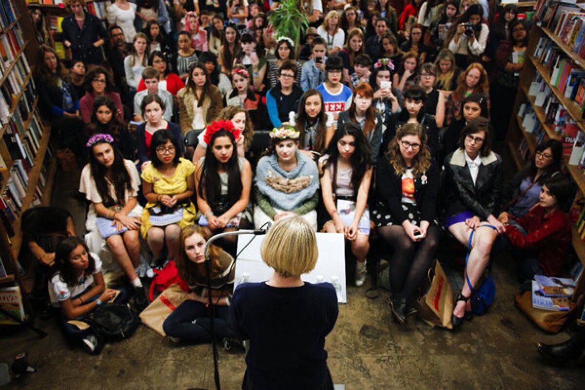 Teen blogger sensation and editor-in-chief of "Rookie" magazine, Tavi Gevinson, 17, reads to a throng of teens at Skylight books in Los Angeles on November 7, 2013. Gevinson, has the ear of a generation of young readers and the media with her online pop culture magazine.
