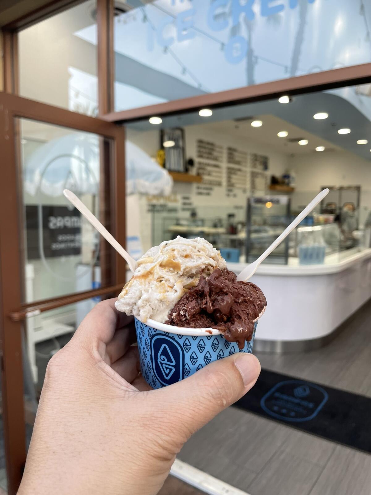 A medium cup at Pampas Helado Argentina in Aliso Viejo, with chocolate alfajor and banana split flavors.