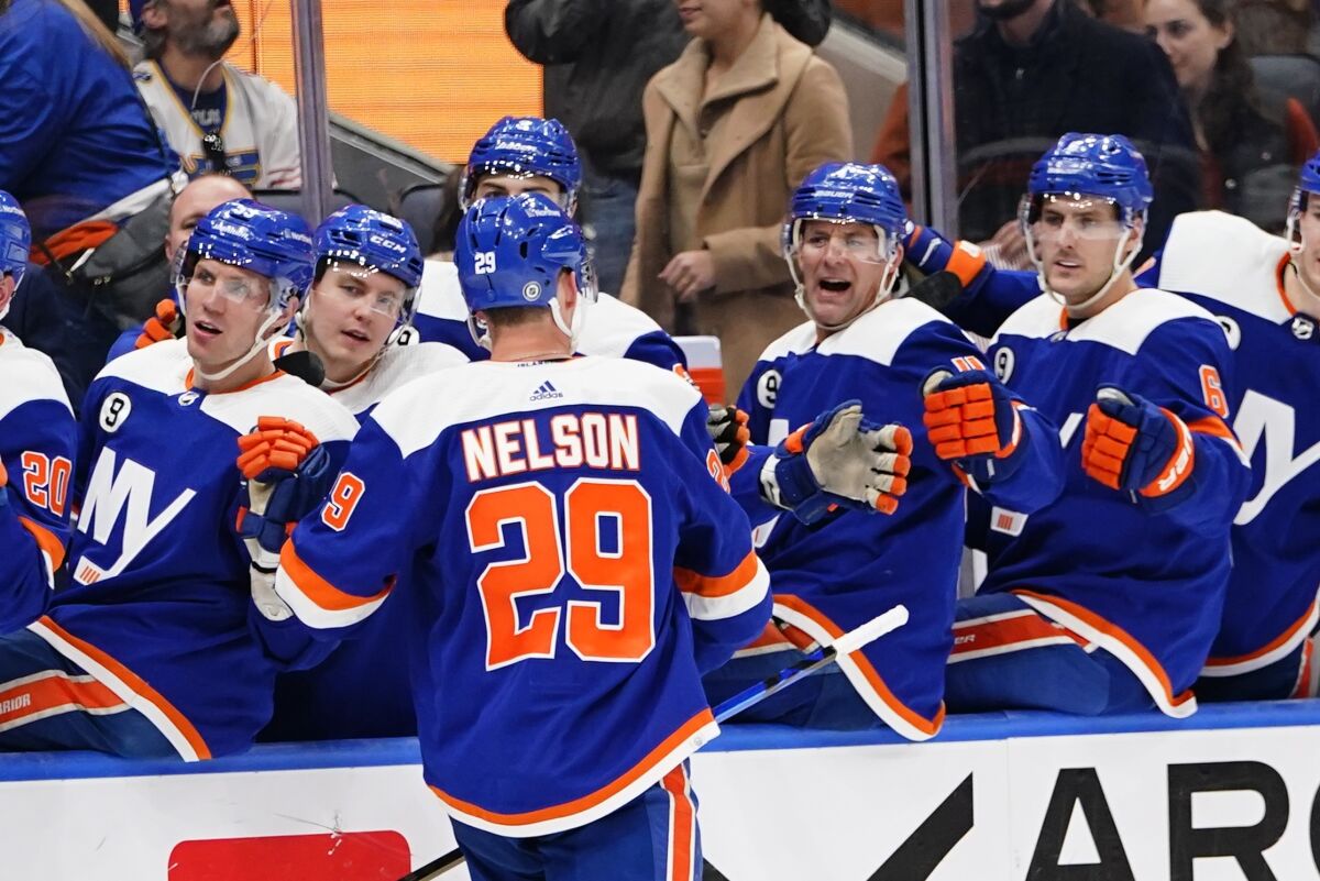 New York Islanders' Brock Nelson (29) celebrates with teammates after scoring a goal during the second period of an NHL hockey game against the St. Louis Blues, Saturday, March 5, 2022, in Elmont, N.Y. (AP Photo/Frank Franklin II)